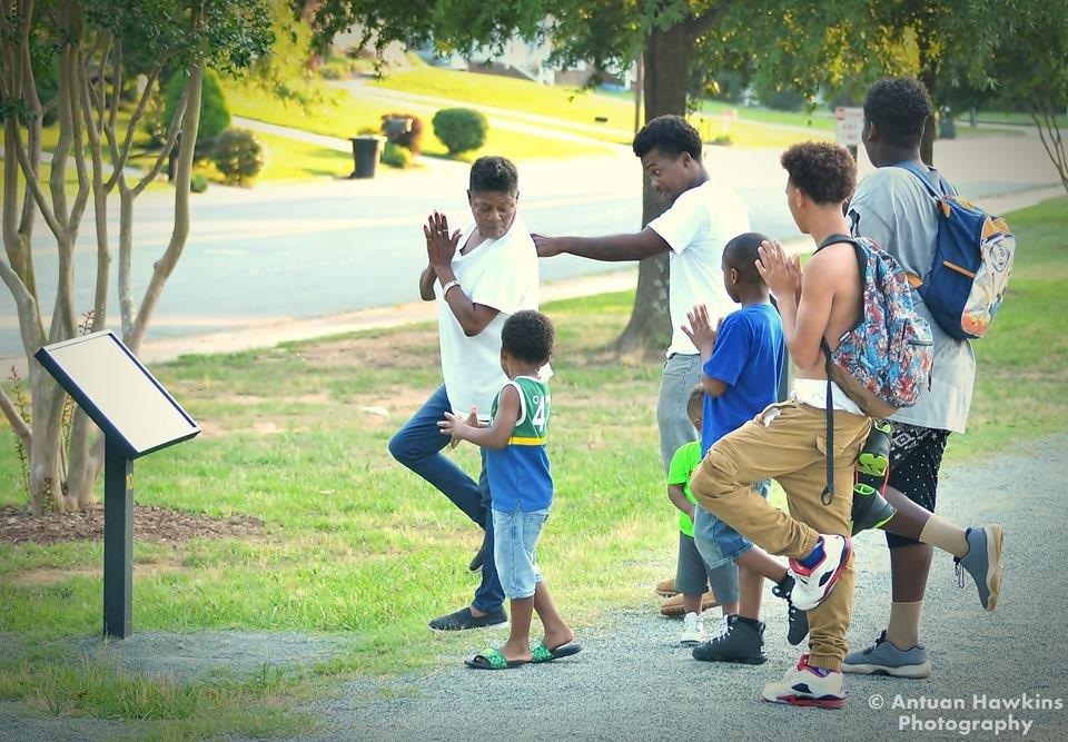 Group of people enjoying the North Park StoryWalk.