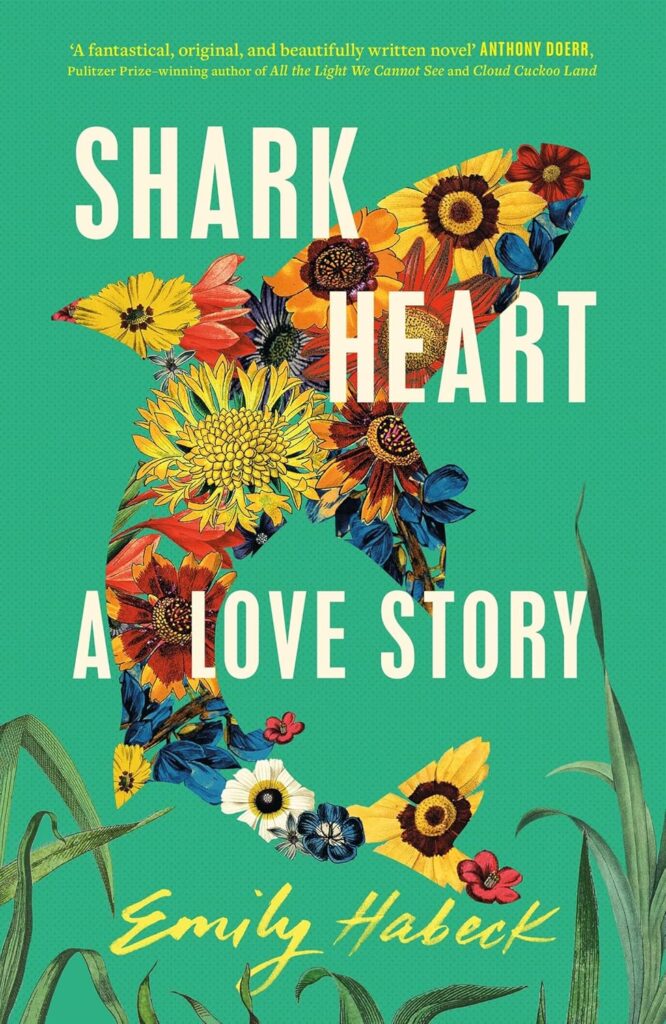 Cover of Shark Heart. Background is green; there are plants growing at the bottom of the cover, and a shark made up of flowers above.