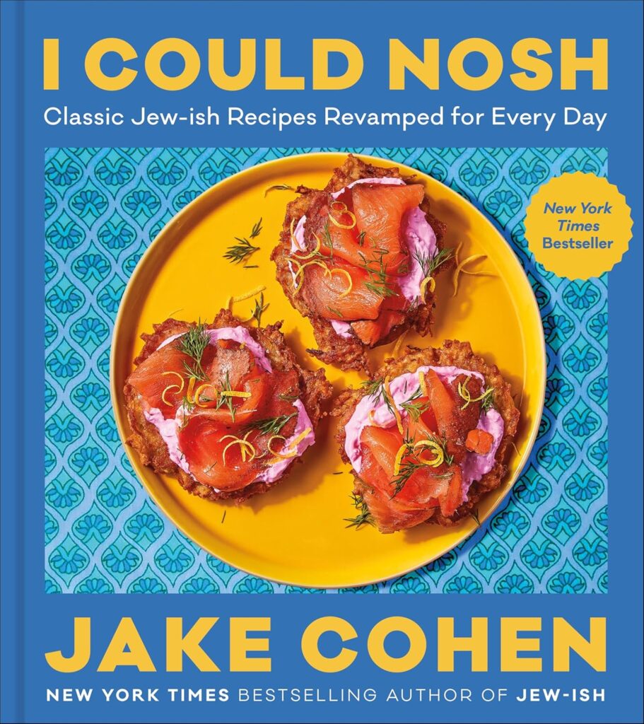 Cover of I Could Nosh. Photo of one of the dishes is on the cover - possibly a potato cake with smoked salmon, garnishes, and some kind of sour cream or cheese-based spread.